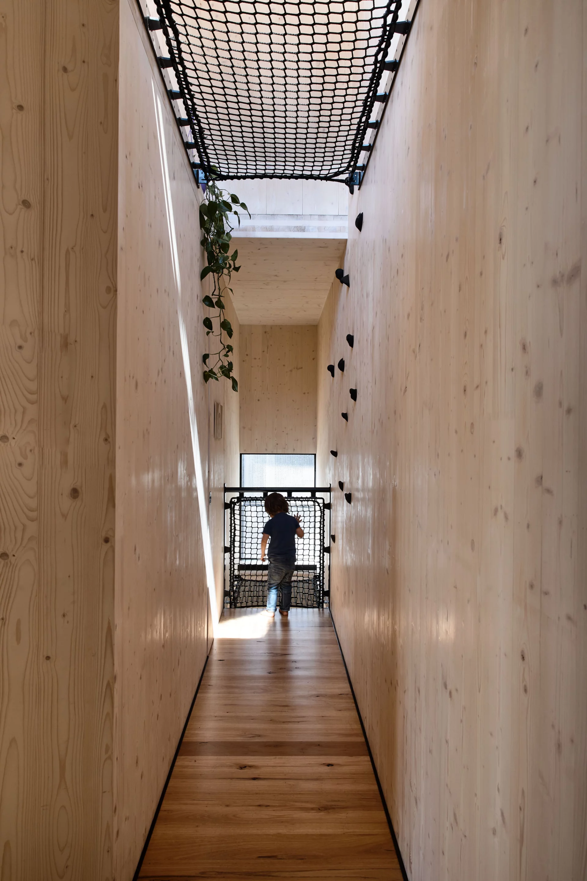 "A ramp, a glazed trap door, a series of climbing holds and nets enable this energetic family to clamber up walls without ever interacting with the stairs," explains Austin Maynard Architects. "A throughly unconventional way to move through a home, and a wonderful way to distract active boys"