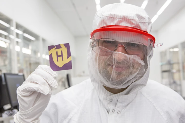 Mikhail Kats displays a piece of paper, that has been colored using the new system (Photo: Eliza Grinnell)