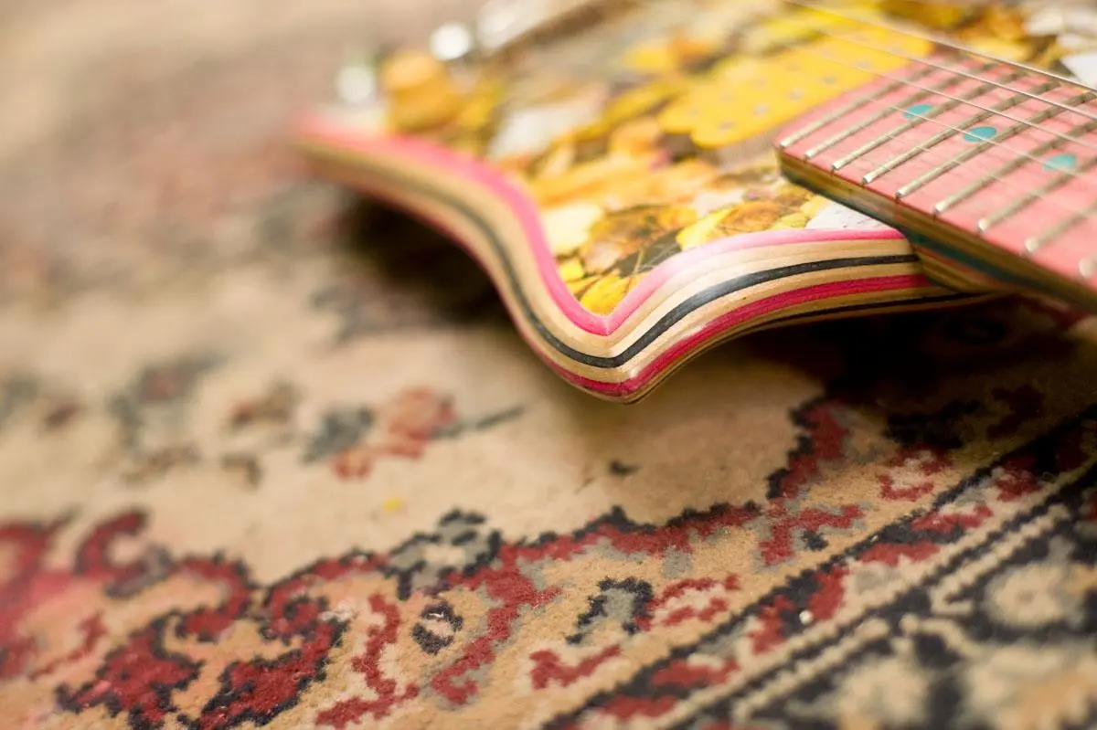Close up showing the layered maple skateboard deck shaped and finished into the body of a Skate Guitar