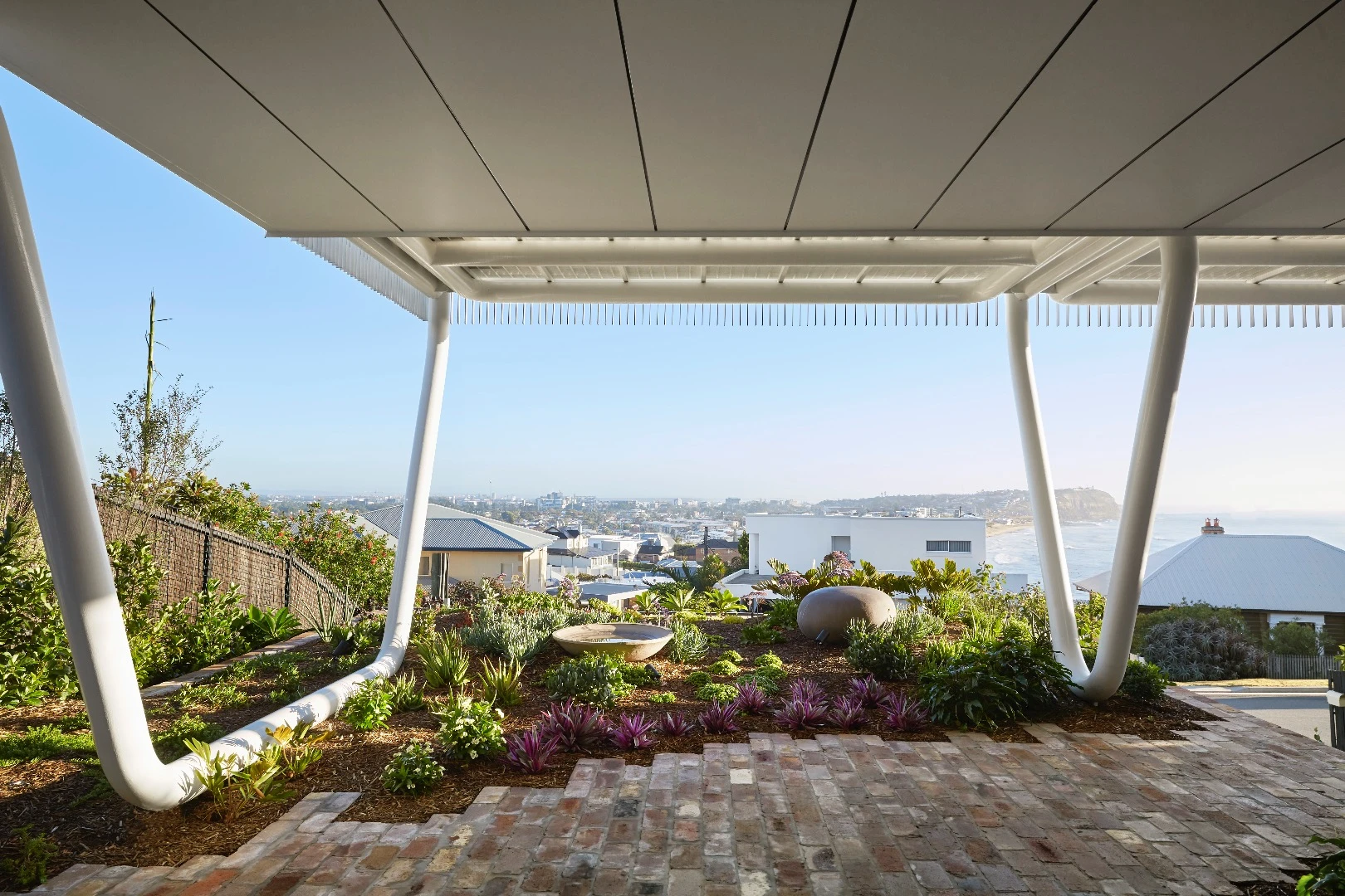 Greenacres is located on a sloping plot close to a cliff overlooking the ocean and city of Newcastle