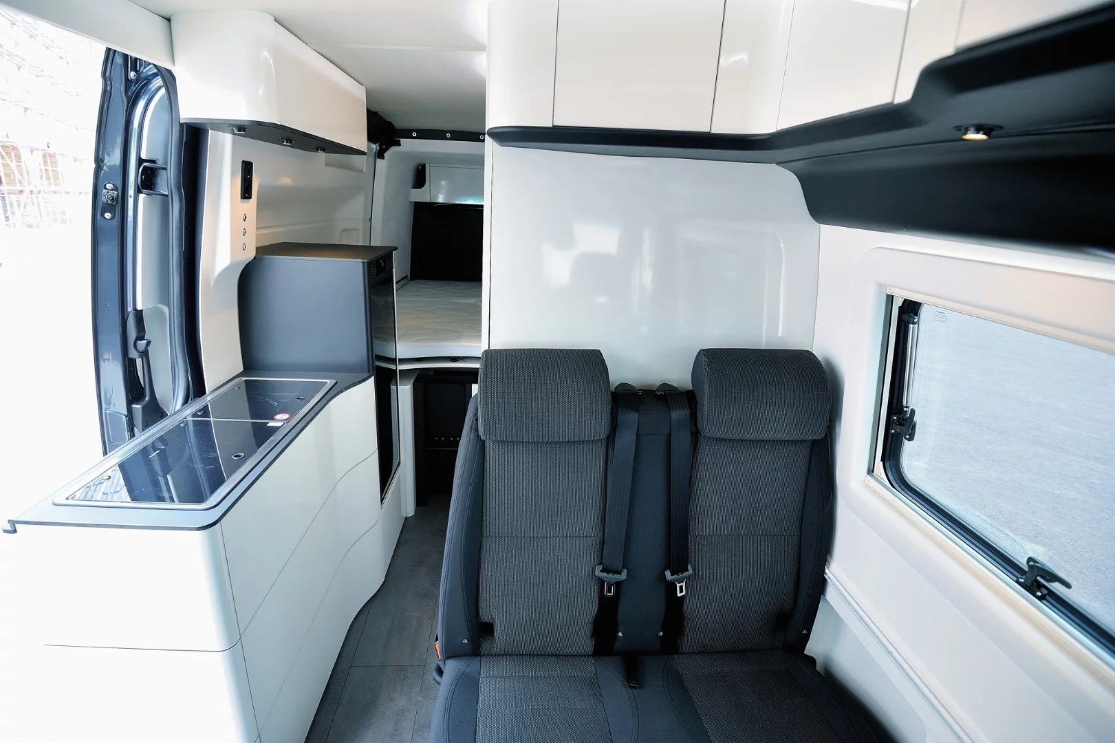 Beyond the expanding rear, the interior is a straightforward European layout with front dinette and central kitchen block