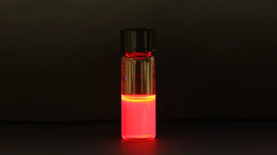 A hybrid crystal formed by combining perovskite and colloidal quantum dots fluorescing brightly in solution