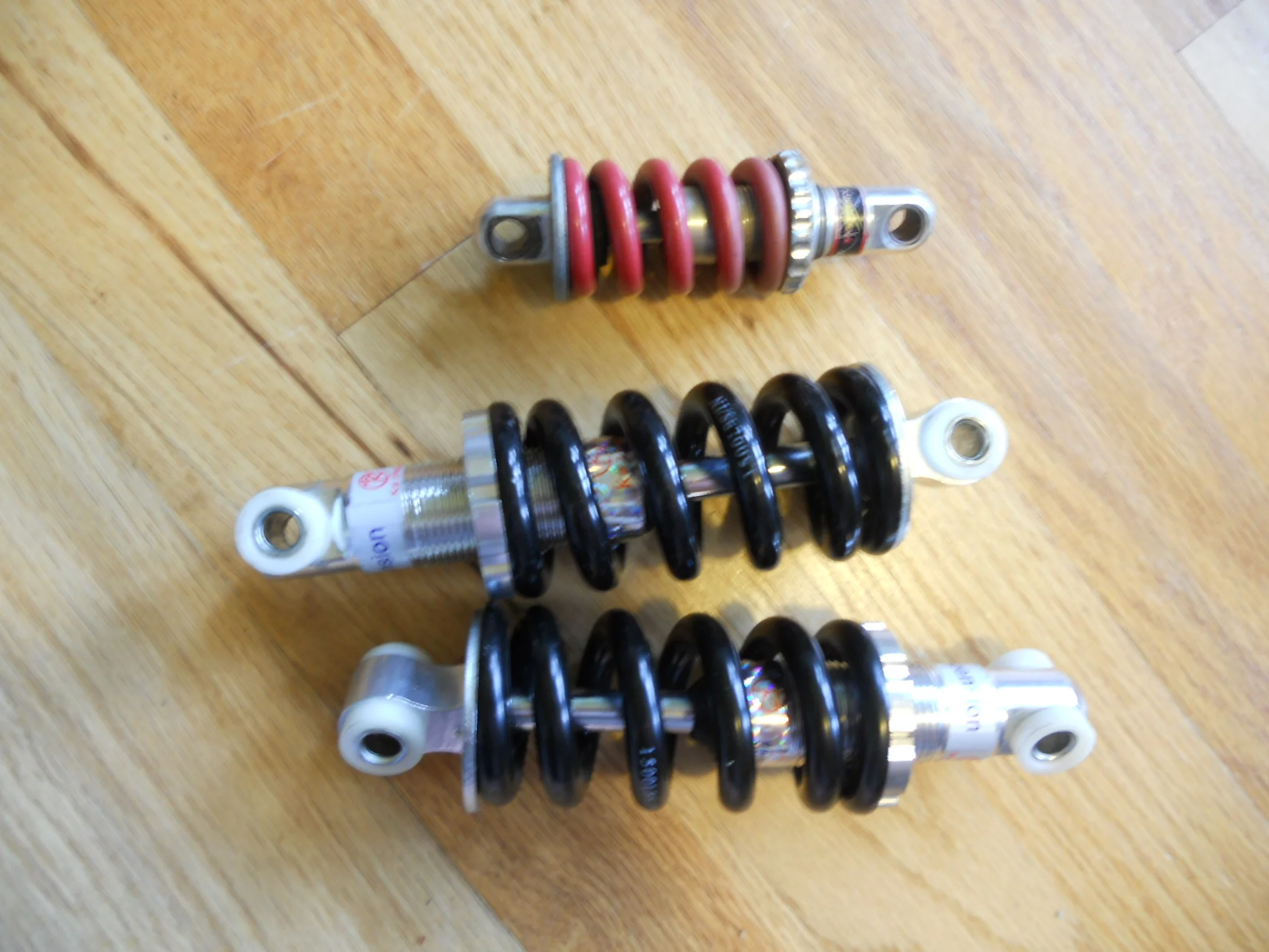 Comparing the size of the rear shock from the Royce Union Transit scooter with those to be used for the build