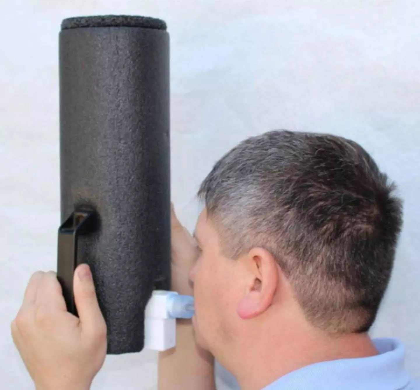 A volunteer breathes into the breath sampler
