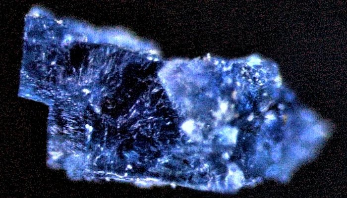 A tiny blue crystal containing organic compounds, taken from one of the meteorites