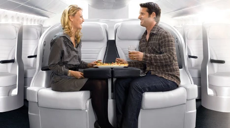 The Air New Zealand Space Seat allows couples to enjoy a shared table (Credit: Air New Zealand)