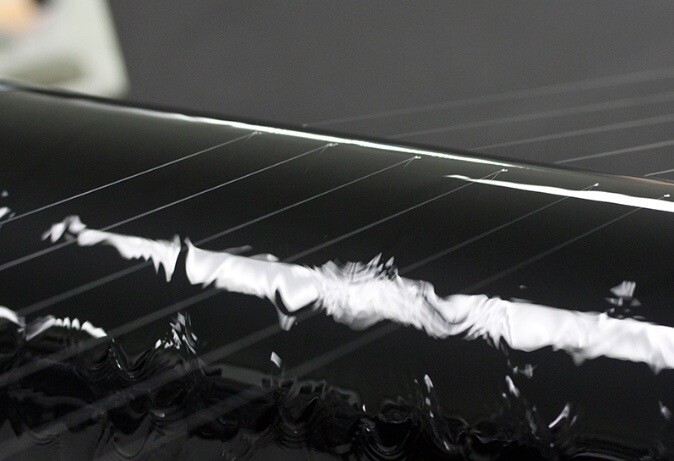 The filaments run over rollers that sit in an ethanol bath, the ethanol coating the filaments and causing them to harden