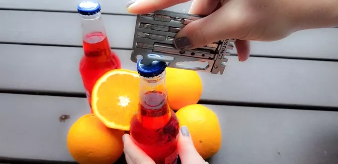 The Distinct multi-tool in action as a bottle opener