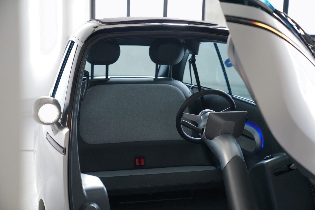 The steering column has been moved from the door to the floor