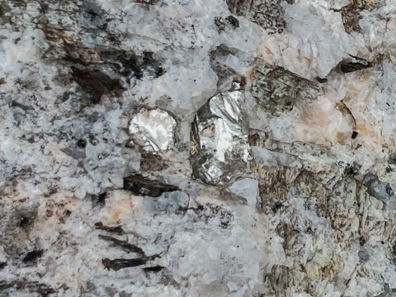 Telltale flashes of silver-white lithium metal in the rock
