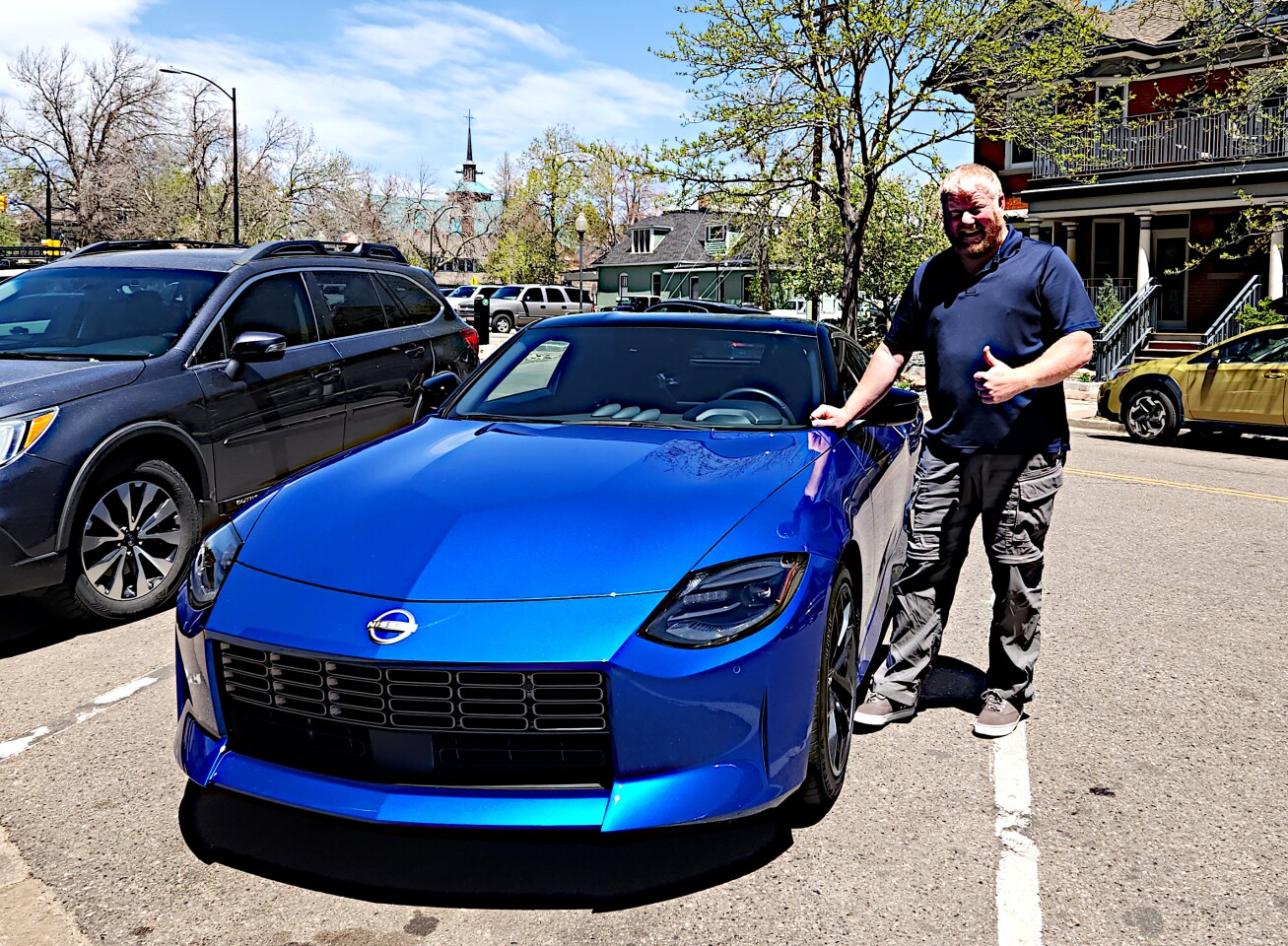 The author poses with the 2023 Nissan Z in Boulder, Colorado, before driving the car
