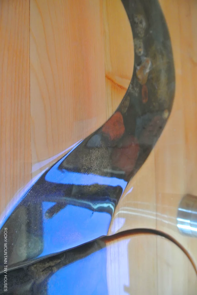 Custom countertop with inlaid river rocks collected by the owners (Photo: Rocky Mountain Tiny Houses)