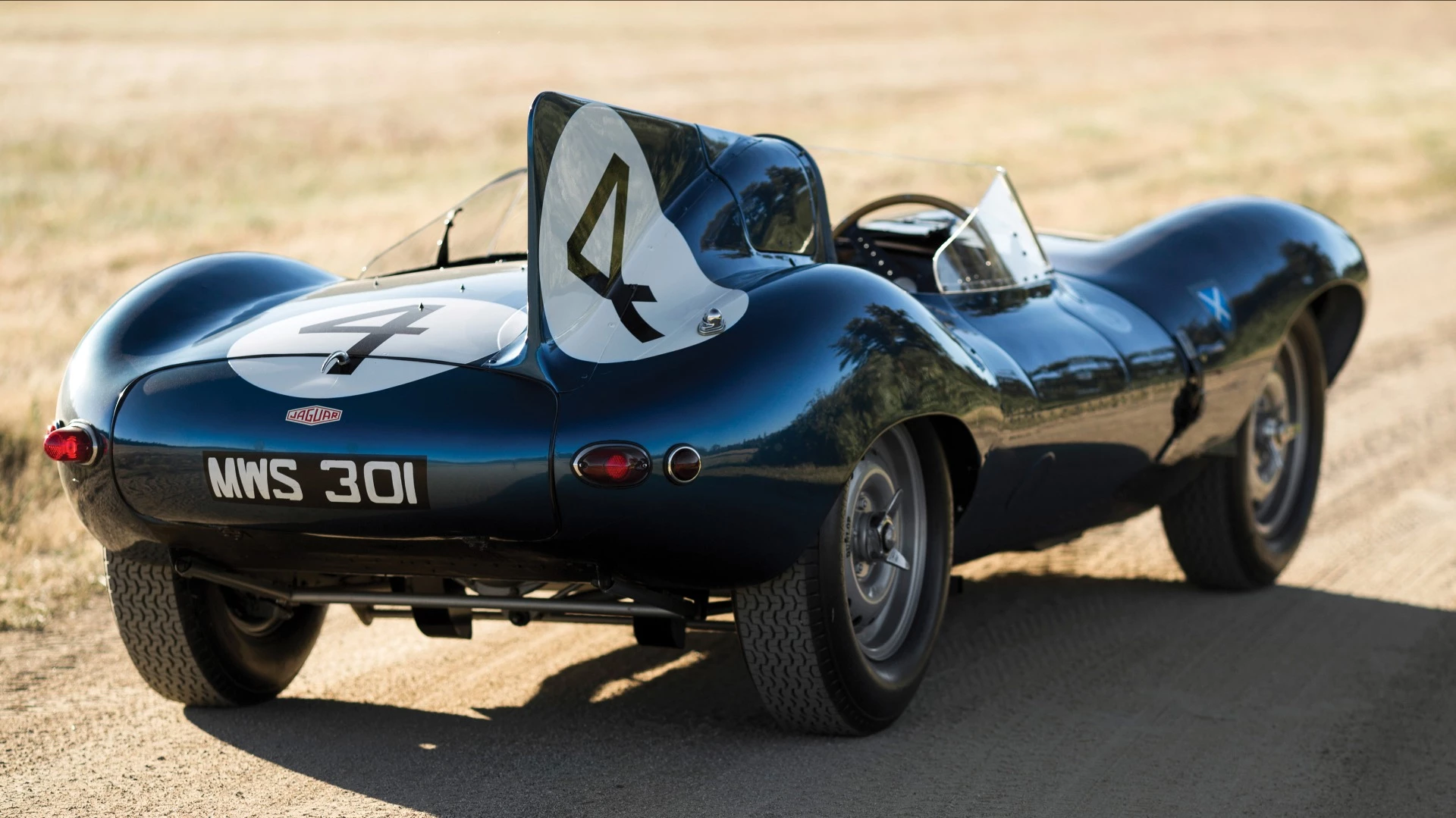This 1955 Jaguar D-Type (chassis no. XKD 501) was the first D-Type supplied by Jaguar to a non-factory team, the famous Scottish Racing team, Ecurie Ecosse, which used it to win the 1956 24 Hours of Le Mans with drivers Ron Flockhart and Ninian Sanderson. The car spent the previous two decades in one of America's leading automotive collections prior to its sale by RM-Sothebys at Monterey, 2016 where it sold for $21,780,000 to become the most valuable British car ever to sell at auction.