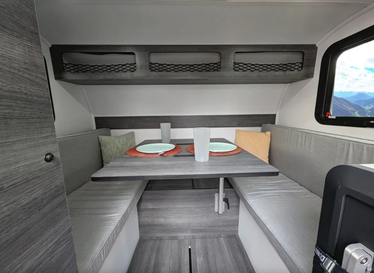 The Arctos Sport interior looks surpisingly inviting with over 6 feet of peak height, a dining area that looks like it could seat four people, and a few different storage cubbies and cabinets