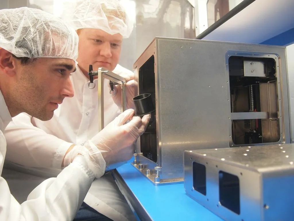 Made in Space CTO Jason Dunn (left) and Principal Investigator Mike Snyder with the 3D Print (Photo: Made in Space)