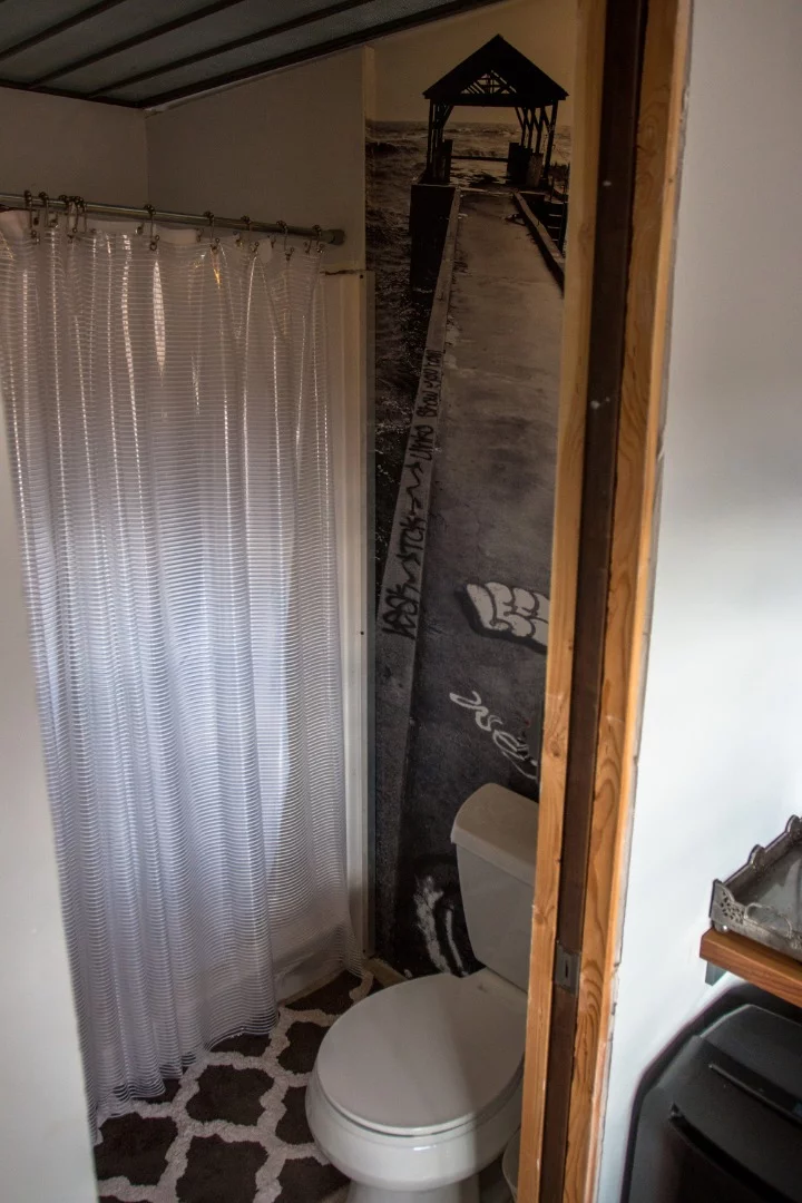 Small but functional bathroom. There is no sink inside the bathroom itself. The sink is located just outside of the bathroom for space efficiency as well as minimizing the about of plumbing required.