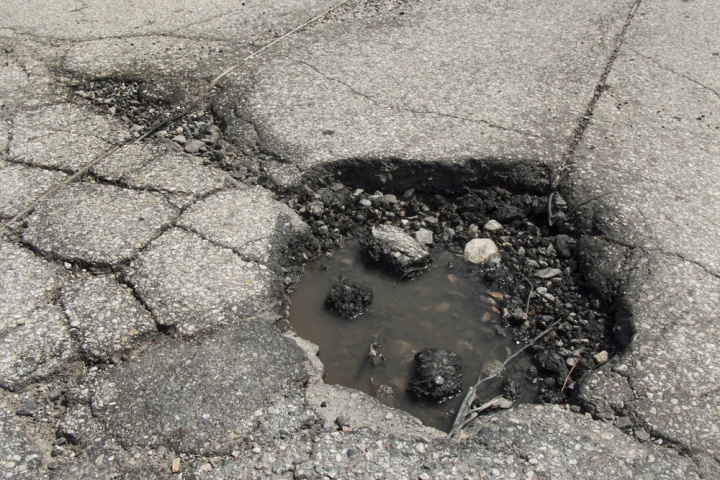 A group of students have created a unique material that they say could be sealed in bags with water, then used to temporarily fill potholes (Photo via Shutterstock)