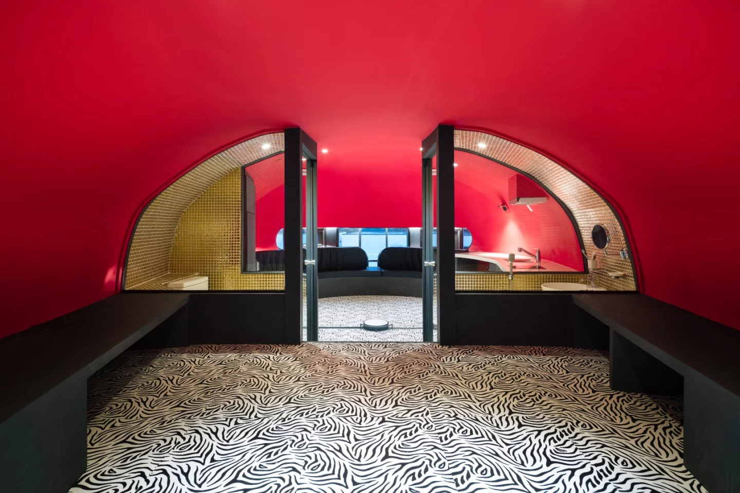 The golden structure is home to bench seating and kitchen, a viewing point, and a bedroom