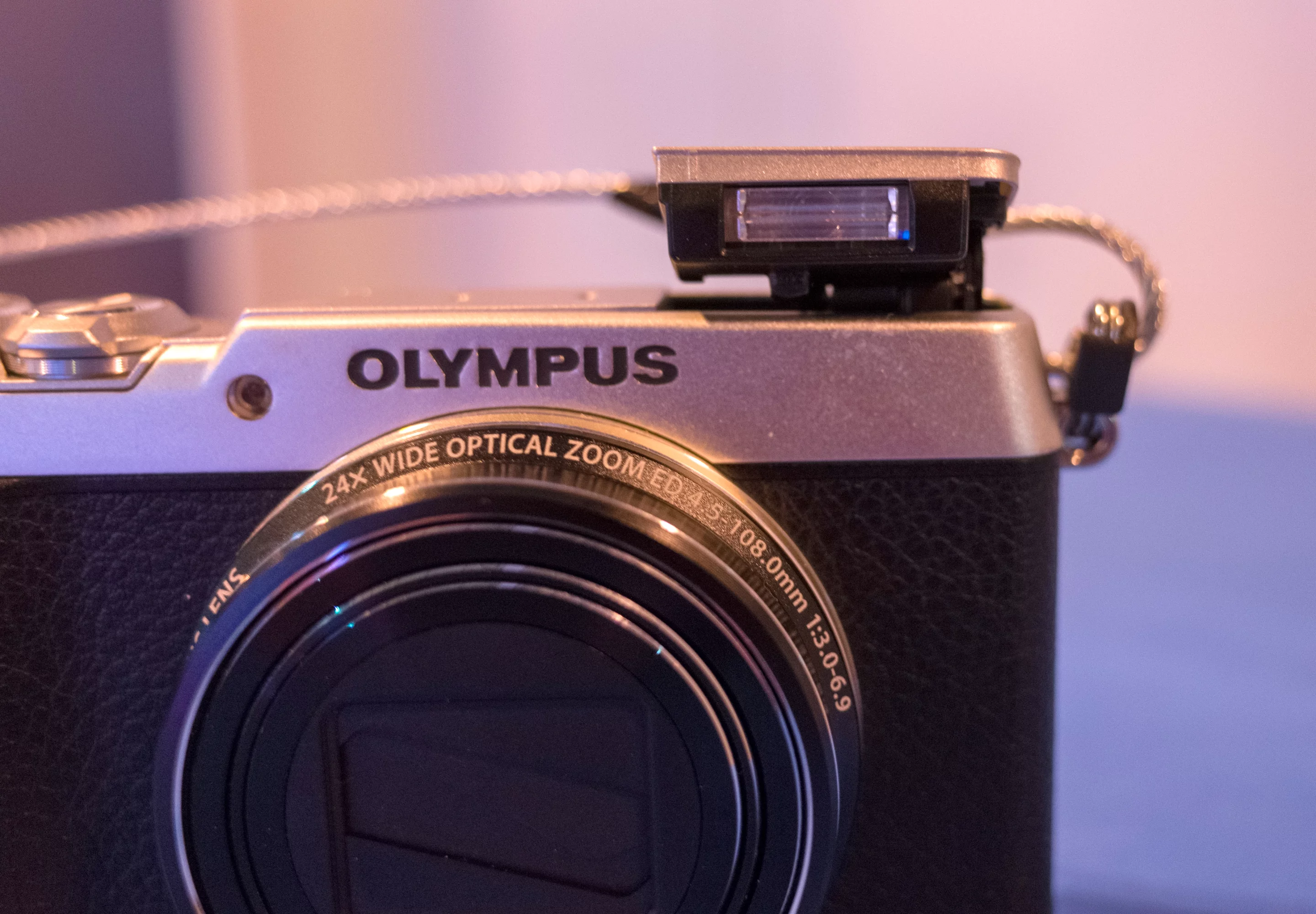 The Olympus Stylus SH-1 has a pop-up flash