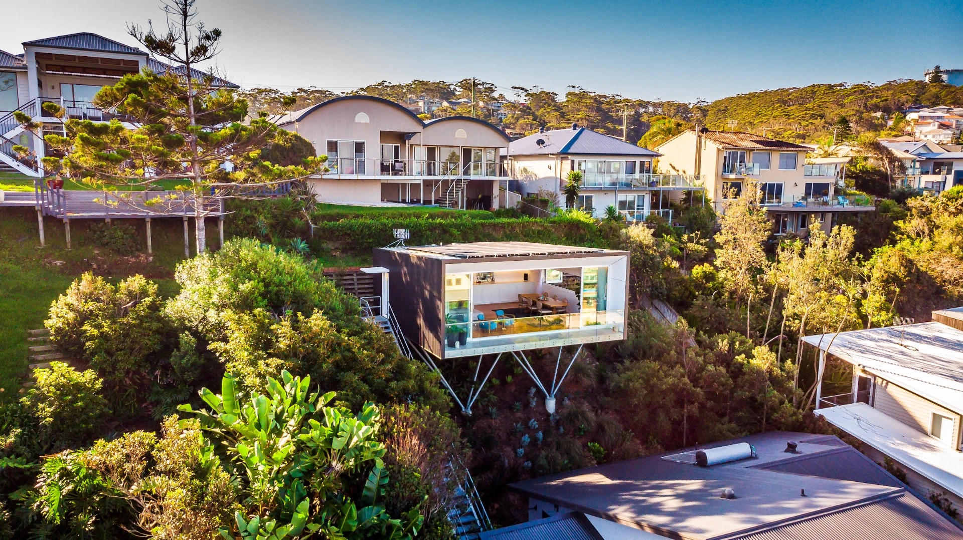 North Avoca Studio is raised on steel stilts and cantilevers impressively over a steep slope