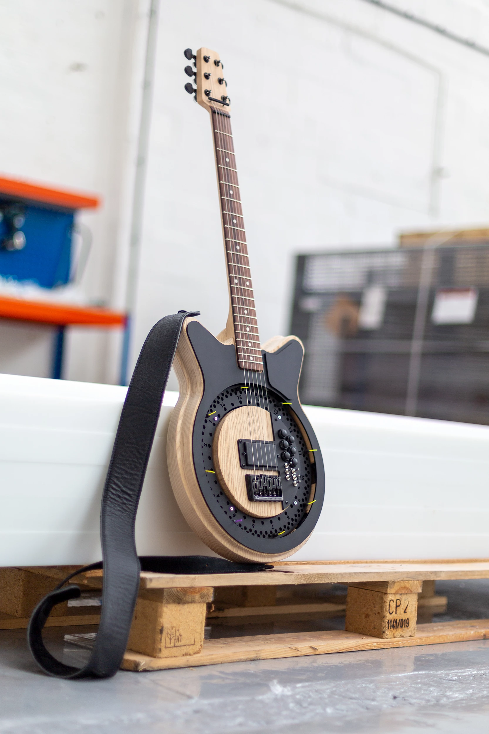 The mechanical components are housed in a single 3D-printed unit, which are hidden from view by laser-cut black acrylic topping the ash body