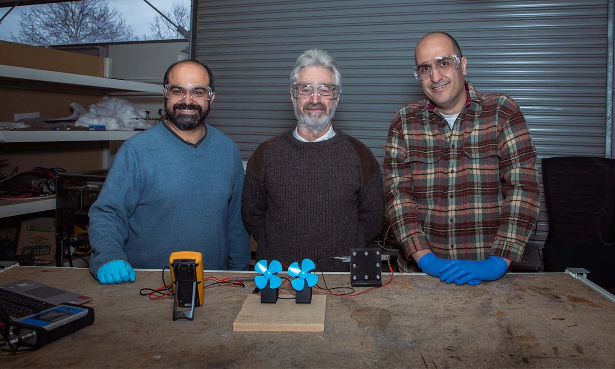 Dr Shahin Heidari (left), Professor John Andrews and Dr Seyed Niya with a demonstration of the proton battery operating two small fans in the RMIT lab
