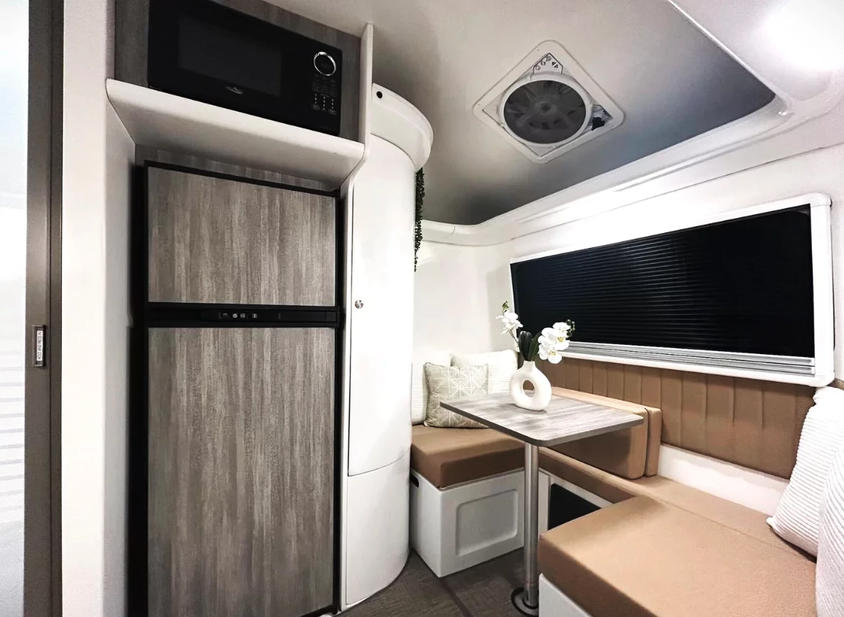 The big addition is the new floor-to-ceiling console with full-size door fridge, microwave and cabinet