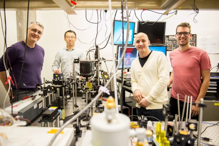 This instrument built by UW engineers (from left) Peter Pauzauskie, Xuezhe Zhou, Bennett Smith, Matthew Crane and Paden Roder (unpictured) used infrared laser light to refrigerate liquids for the first time
