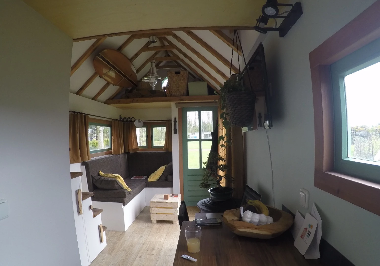 On entering the tiny house, visitors are greeted with a decently-proportioned living space with couch (with storage space), table and kitchenette