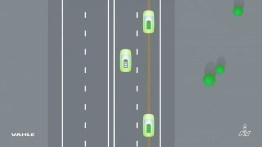 Electrical conductors buried in the roadway generate a magnetic field, which induces current in a pickup on the underside of the car, without actual physical contact