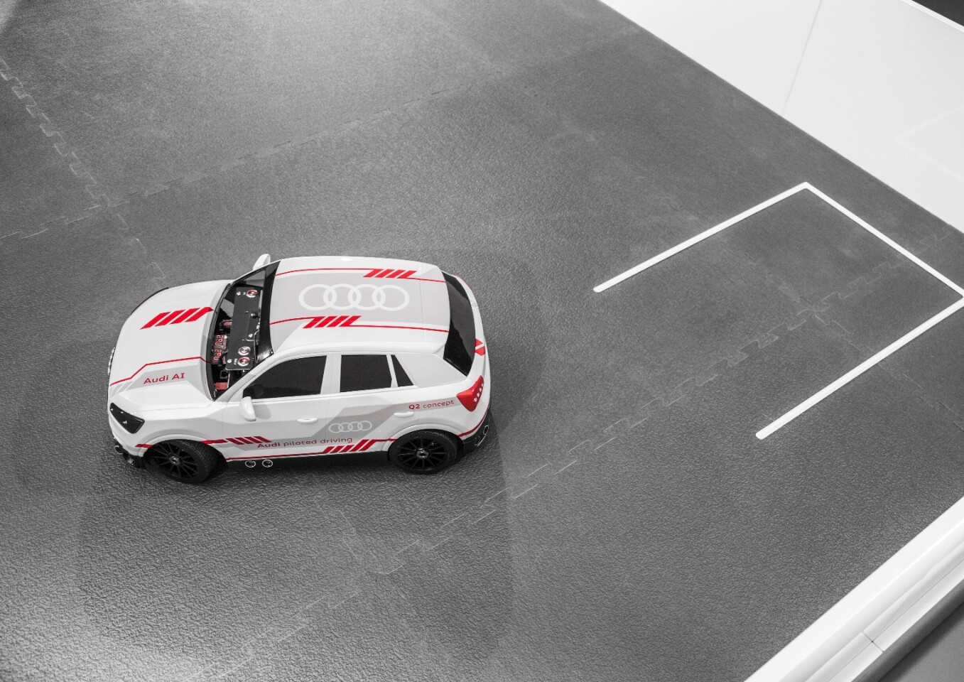The 1:8-scale model Audi parks within a model parking lot