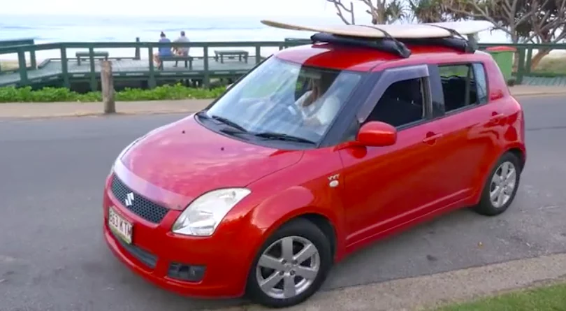 The Tair roof racks with a surfboard attached