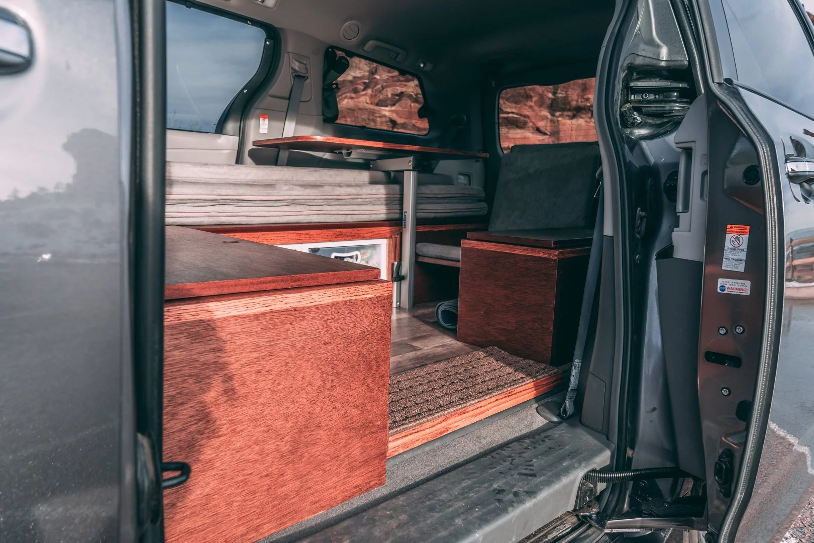 Oasis' interior is made up of a series of structural storage boxes and a convertible lounge/bed