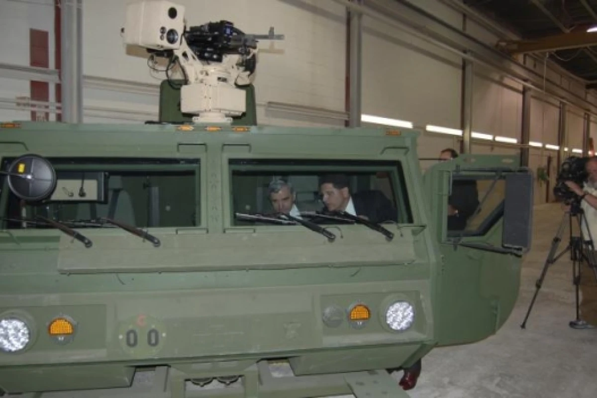 Steve Nimmer, of Oshkosh Truck Corporation, (right) demonstrates the operation of the HEMTT A3 all-composite cab to Rhode Island Senator Jack Reed (D-RI).