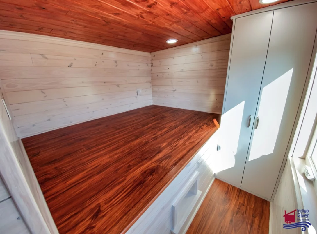 The Sandy tiny house's upstairs bedrooms include raised platforms to host queen-size beds