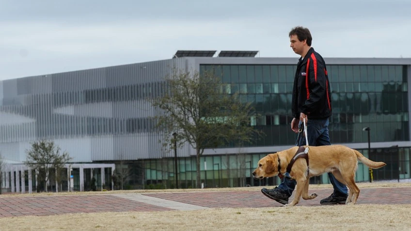 PhD student Sean Mealin (seen here with Simba) is lead author of a paper on the research, and is also blind himself
