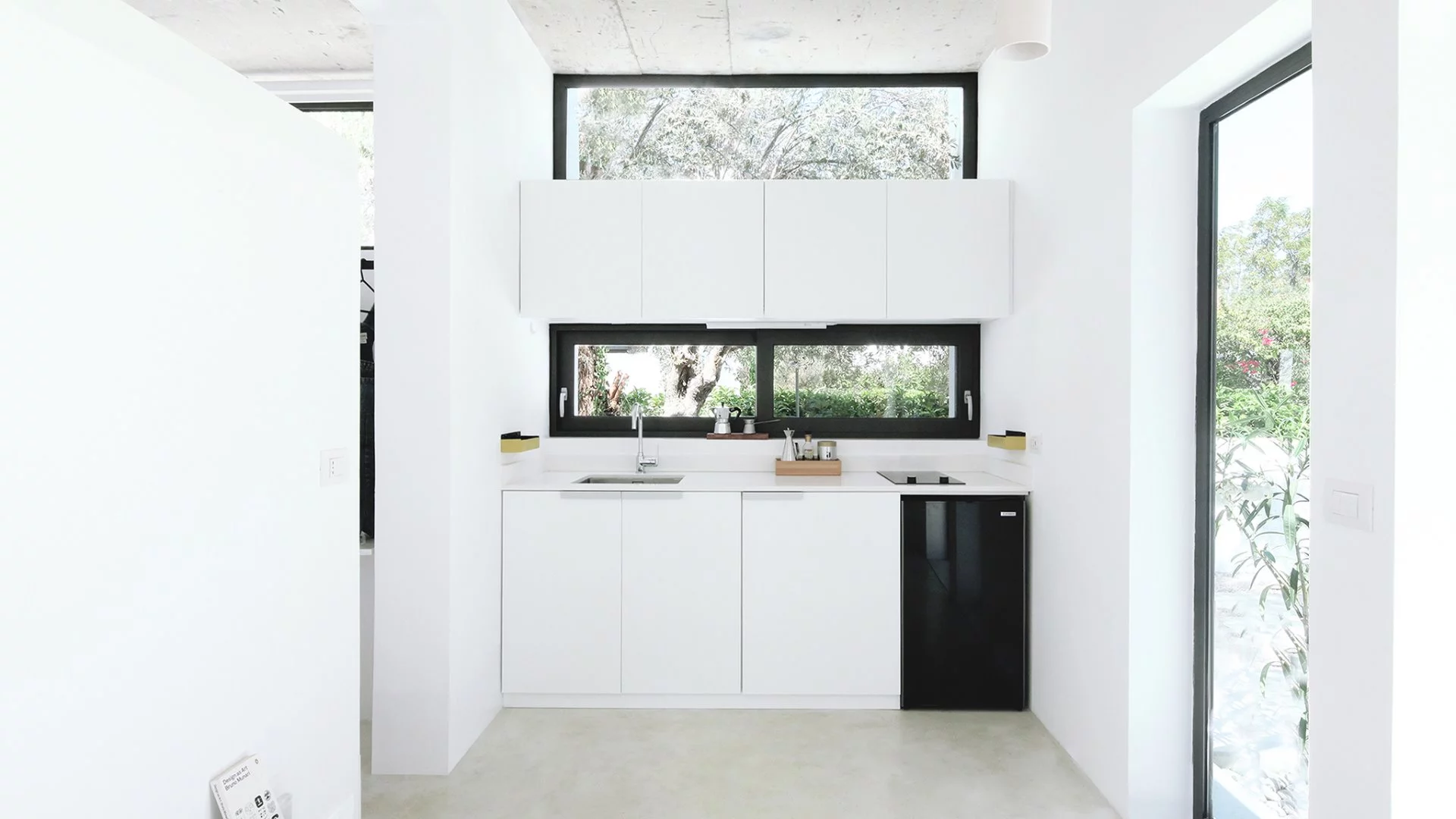The Monocabin features a combined living and dining area with European wall kitchen