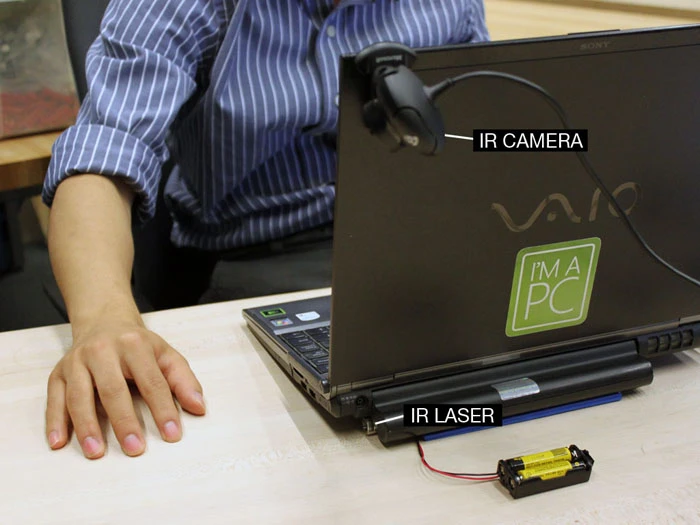 Using an Infrared laser and tracking camera, the Mouseless system registers and interprets a user's hand movement and translates it into onscreen actions