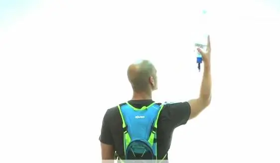 When using a bottle simply hold it above your pack so that water drains via gravity