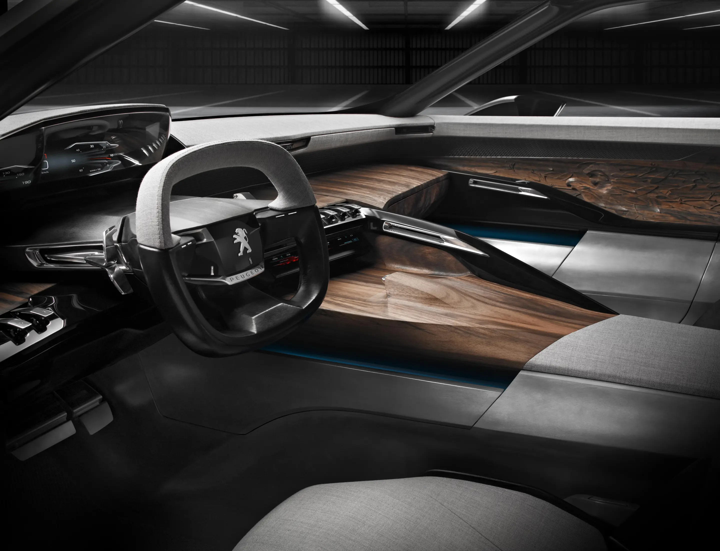 A digital instrument panel backs the small, squared off steering wheel