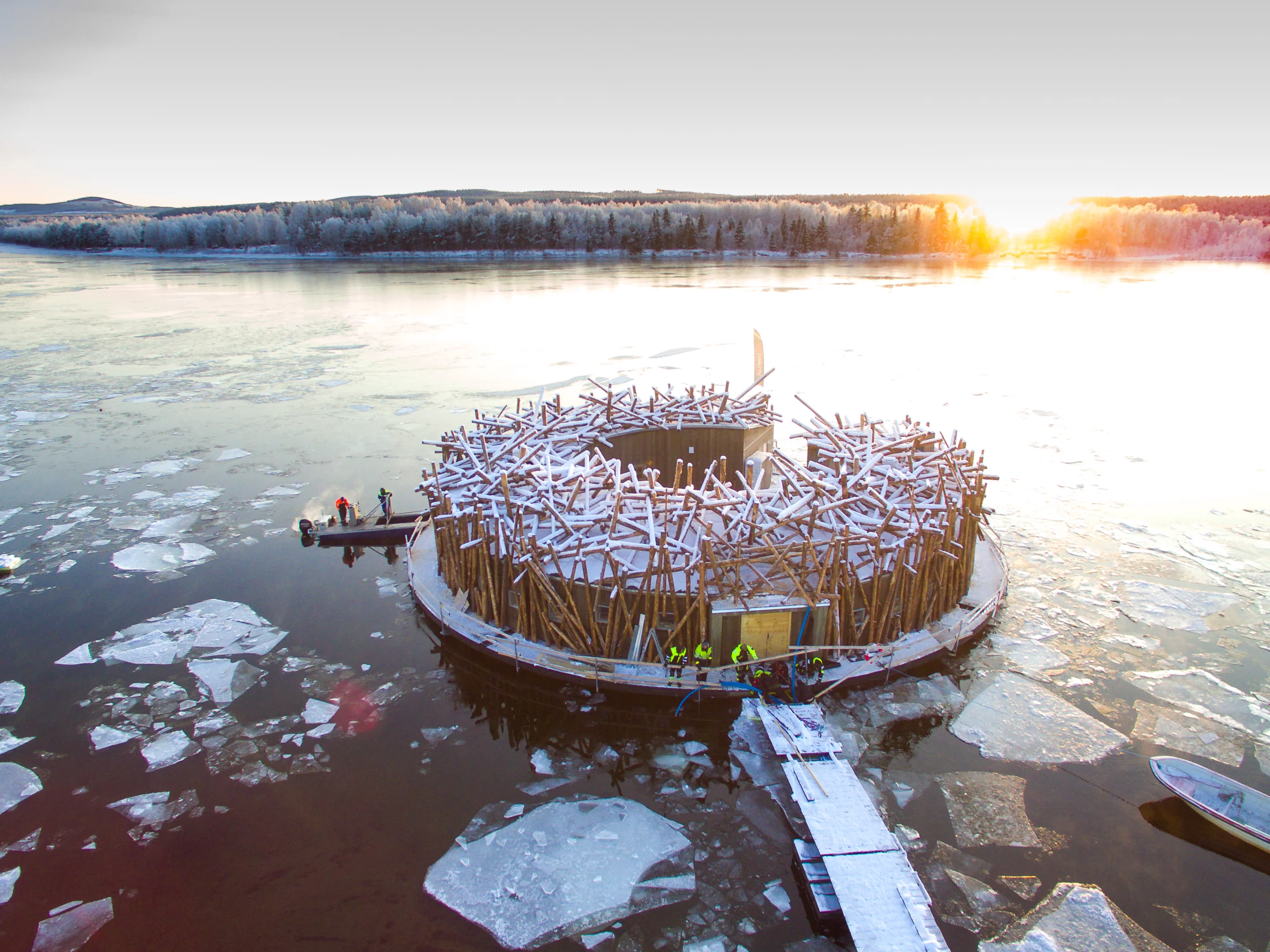 The Arctic Bath is located on Sweden's Lule River, which was once used for transporting timber and the design of the main circular building pays homage to this with a logjam-like facade