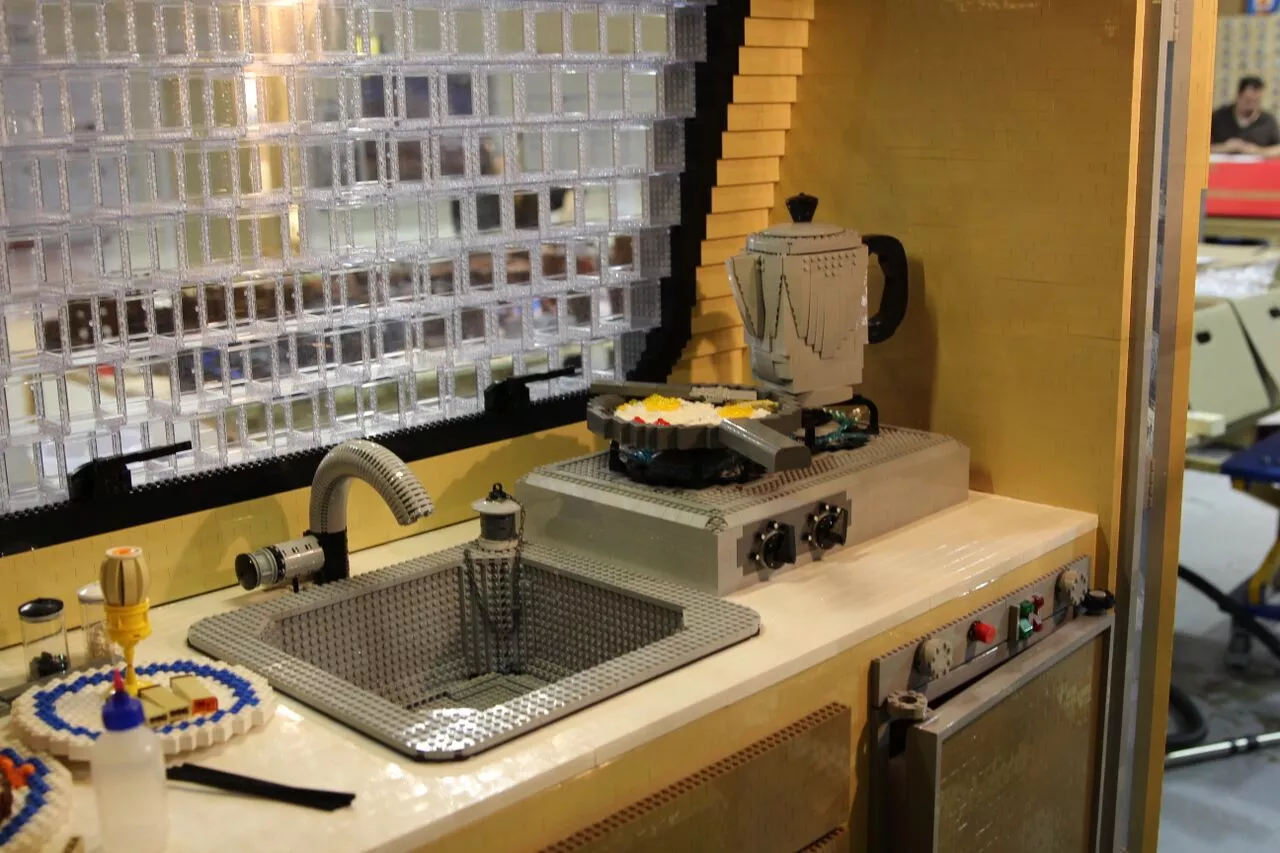 The trailer has real camping amenities, including a sink with running water, working electric lights and a dinette set that transforms into a bed