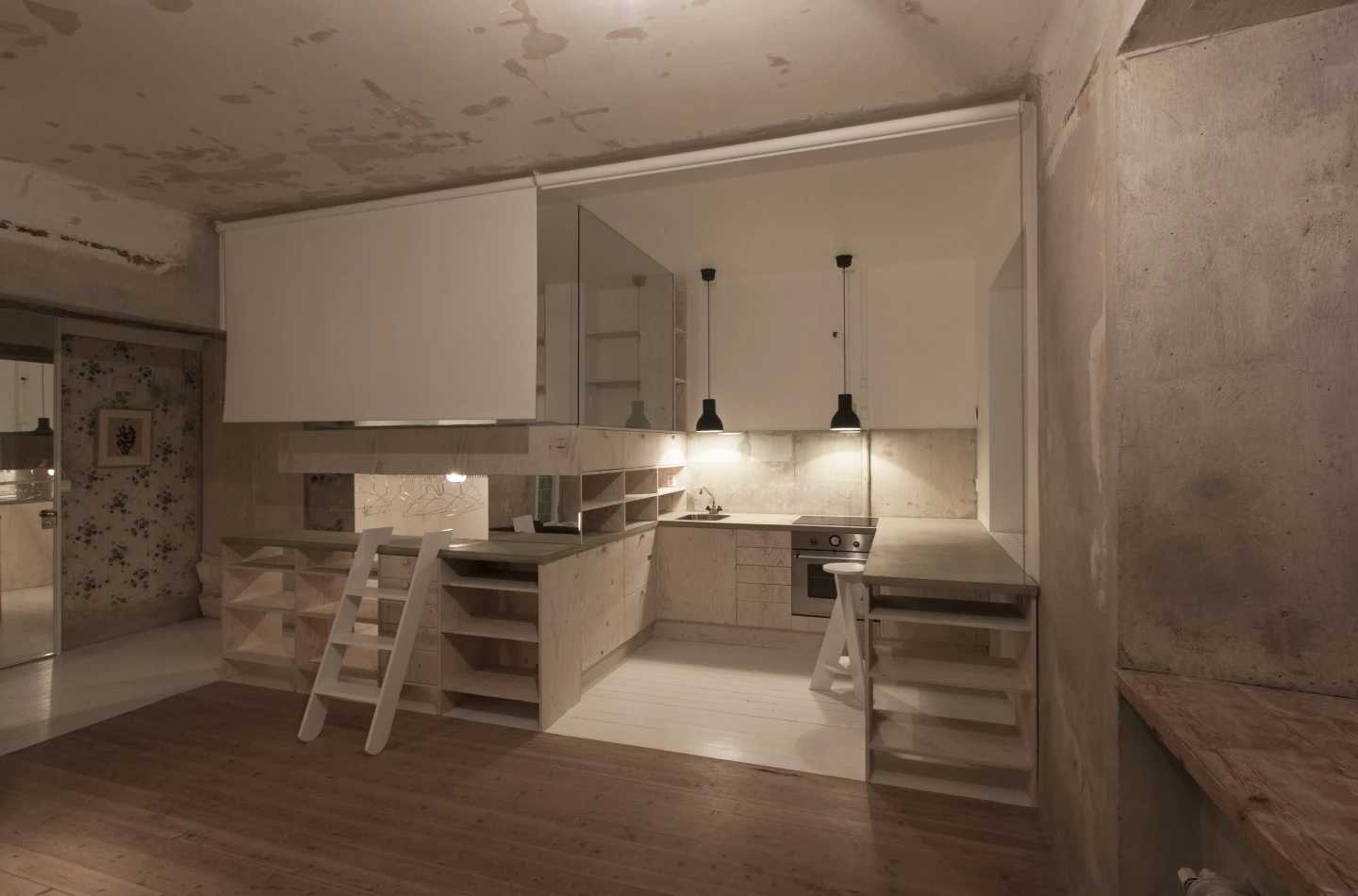 Glass panels are used to separate the kitchen/bed/wardrobe spaces from each other