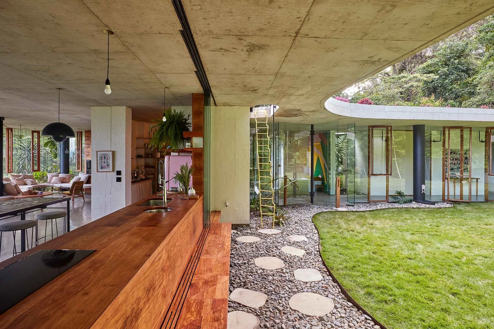 Kitchen benches and courtyard inside the award-winning Planchonella House