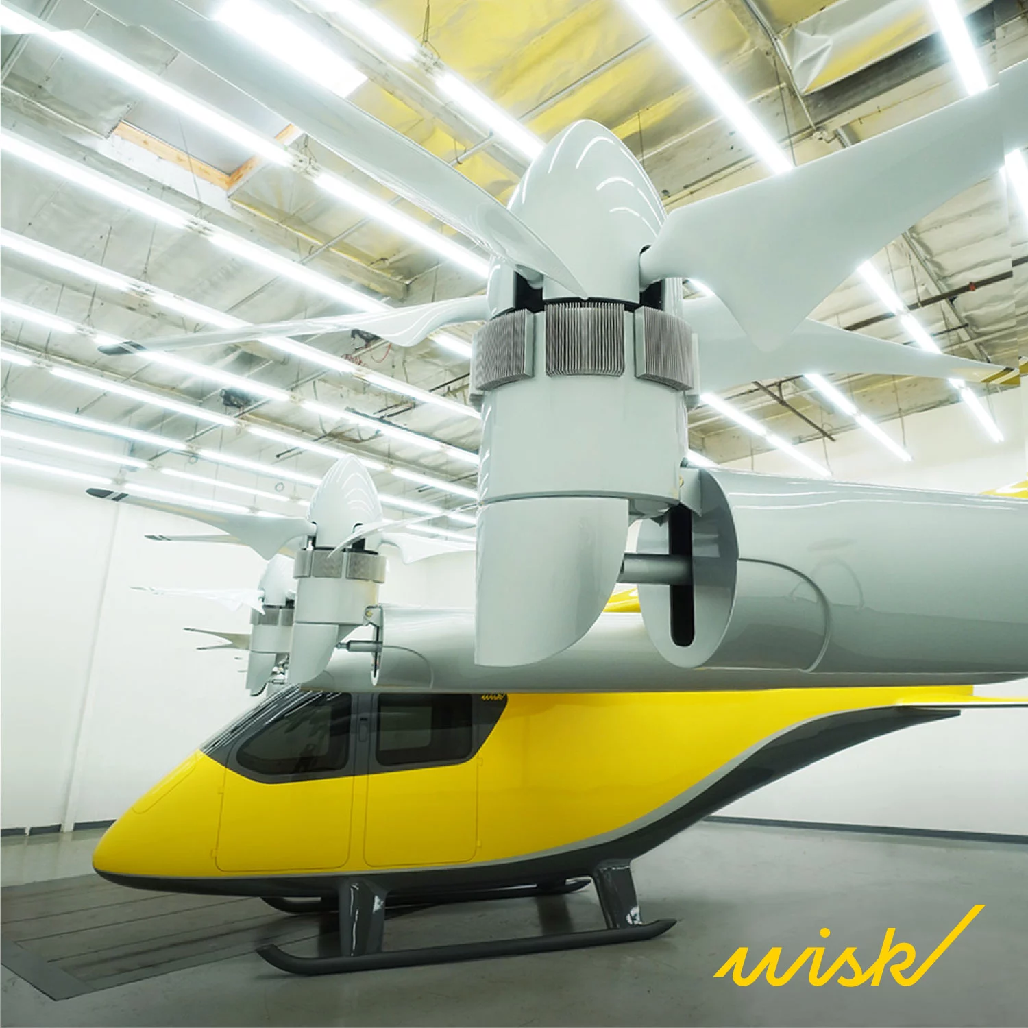 The aircraft sports six 5-blade props to the front of the raised wing that transition from vertical liftoff orientation to horizontal cruise mode, plus six more 4-blade lift props to the rear that lock in place during forward flight
