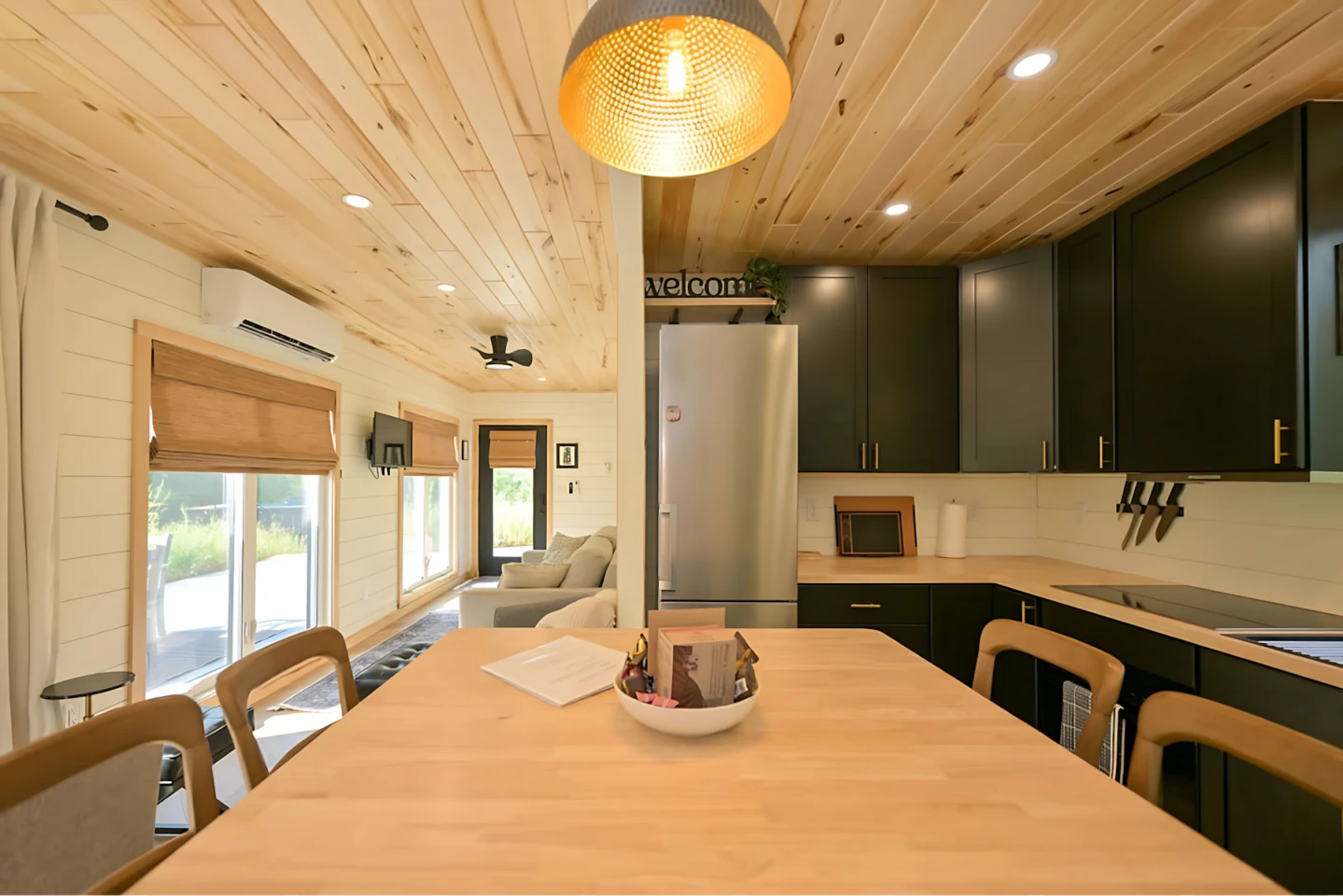 Maison Flambeau's kitchen is spacious and includes lots of cabinetry and a large dining table