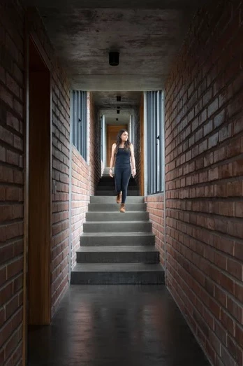 The internal concrete staircase navigates the steep slope the home is positioned on