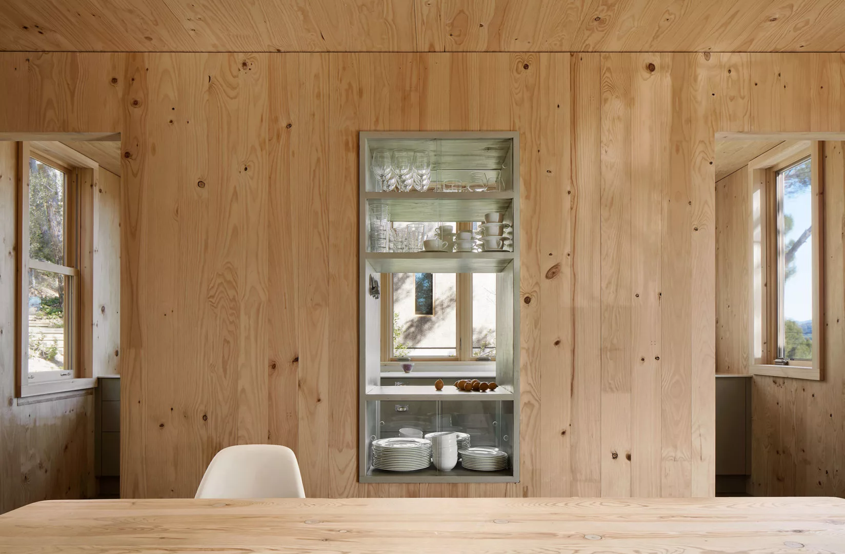 The home also boasts built-in timber furniture, including display cabinets in the kitchen and timber dining table