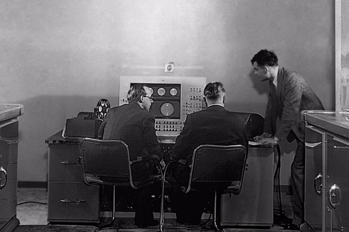 Turing (right) at the console of the Ferranti Mark I