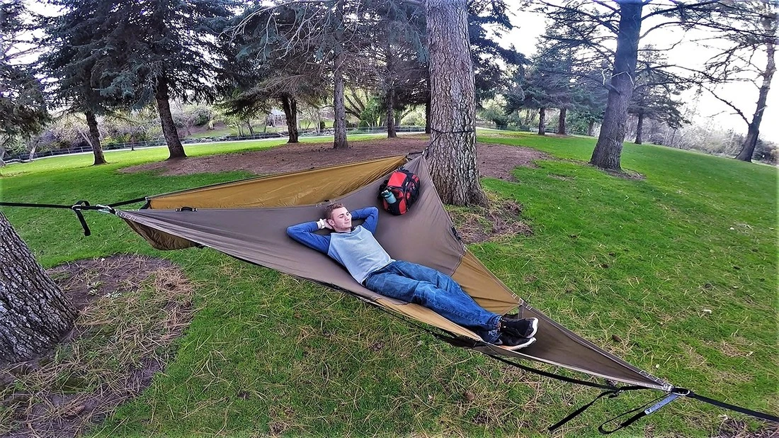 The Treble Hammock 2.0 attaches to three roughly triangular points – usually trees – using strapping